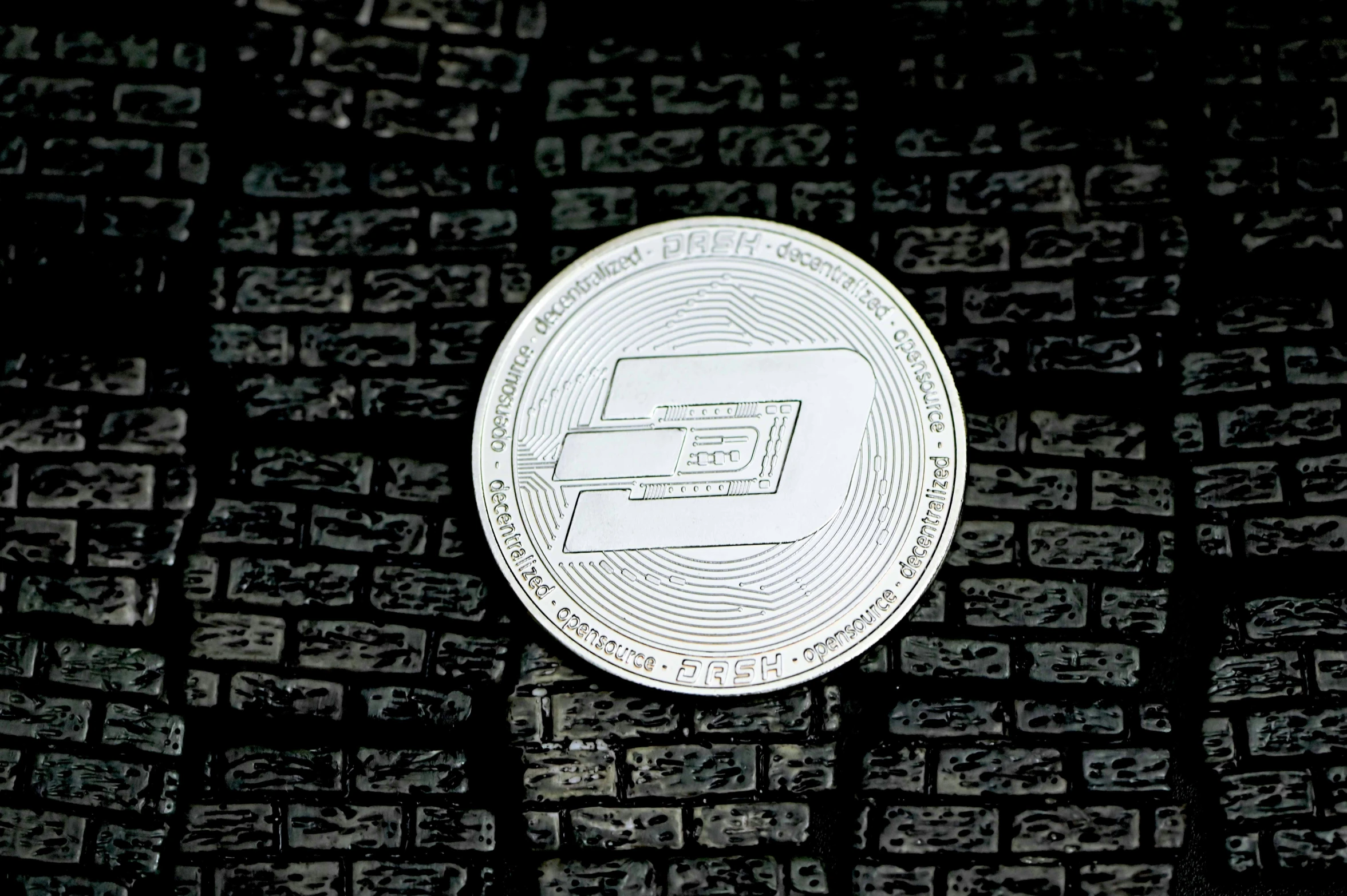 a bitcoin surrounded by the letters on a brick background