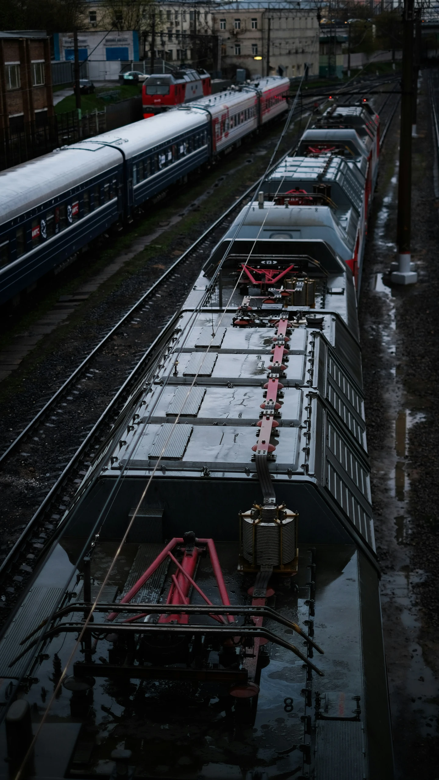 three trains stopped at a train station with no passengers