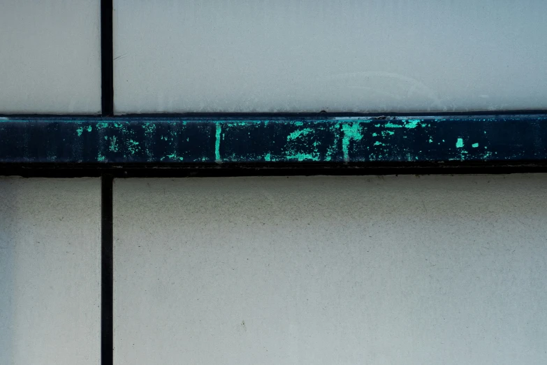 a metal shelf painted turquoise and with a white base