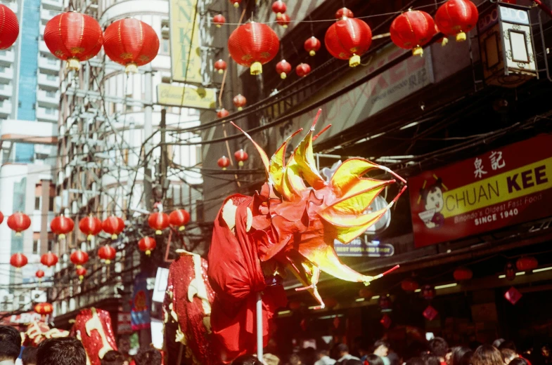 many red lanterns float above the street on display