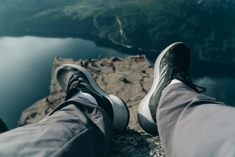 person standing on top of a mountain overlooking water