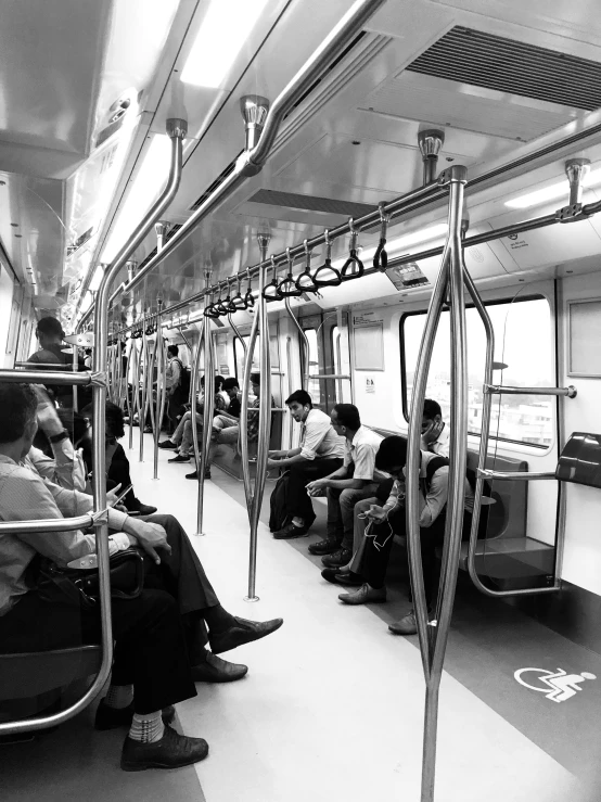 a black and white po of people sitting on a train