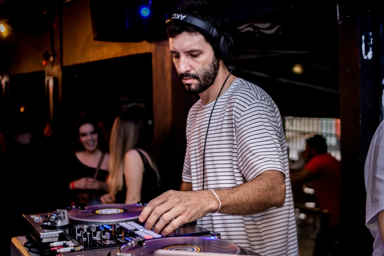 a man at the decks of a record player's turn table