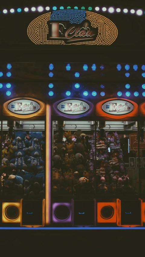 a lighted clock stand in front of a carnival ride