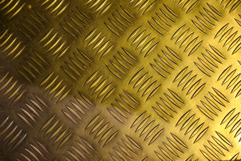 a gold metal textured with several rows of wavy lines