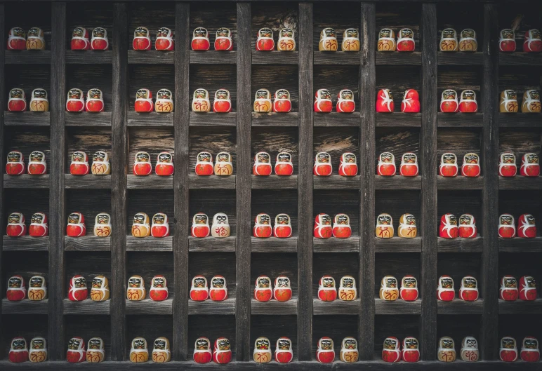 a shelf with lots of red bottles in it