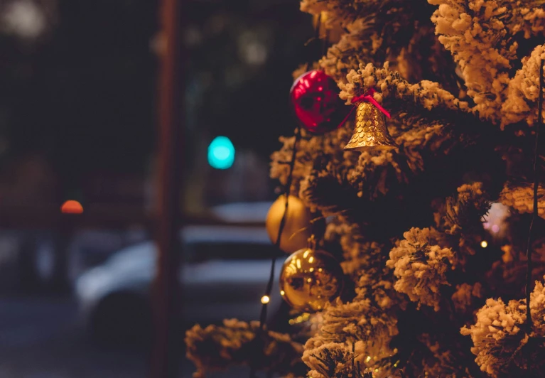 a yellow tree with red balls on it