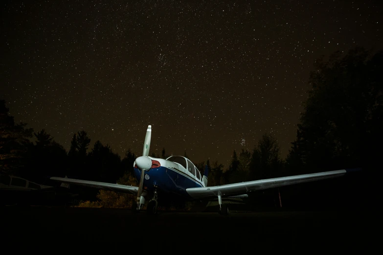 a plane sitting alone at night in the dark