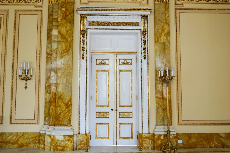 an entryway of a building with golden walls and a door
