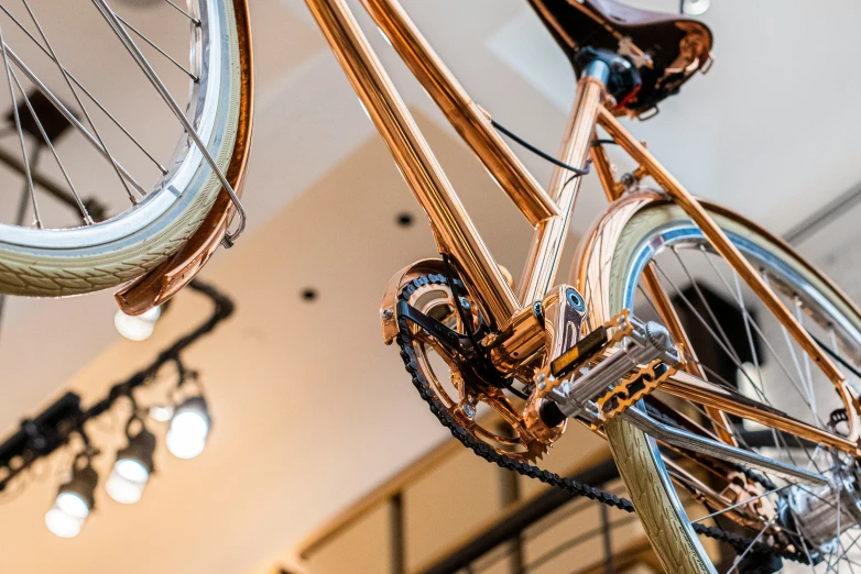 there is a golden bicycle hanging from the ceiling