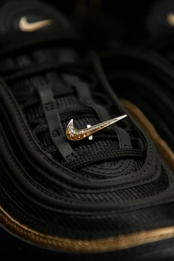 a black pair of tennis shoes that have a tiny sparkle on them