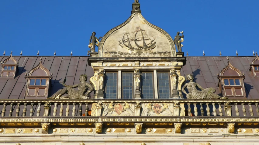 a building with some windows and a roof and a blue sky