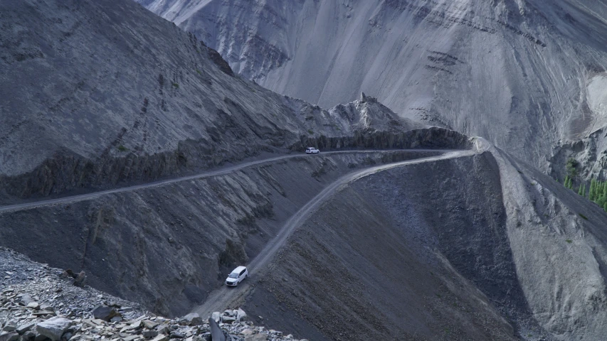 the view of a road winding through the mountain side
