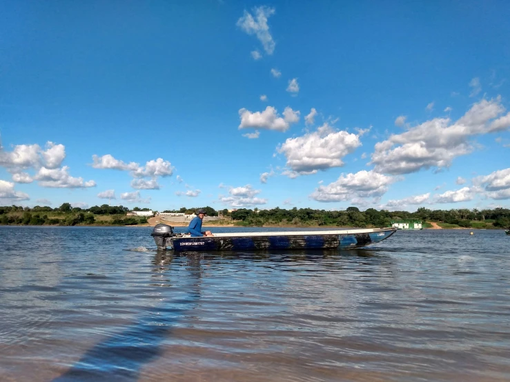 a man standing on the side of a boat