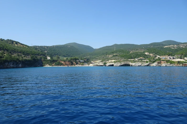 water and hills are all behind a large body of water