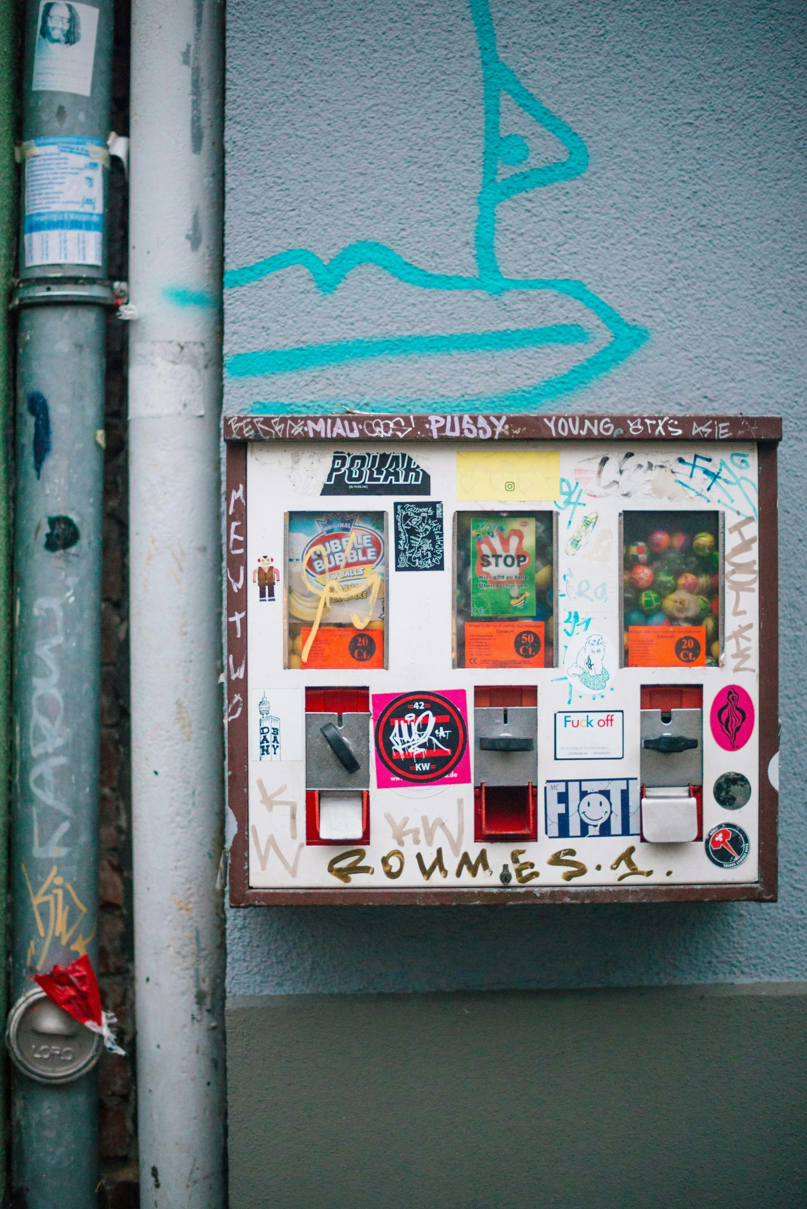 a public phone booth with graffiti on it