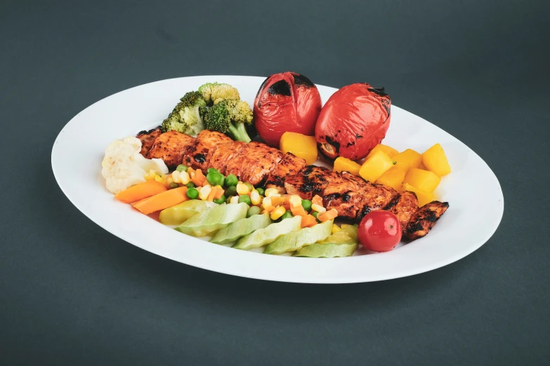 a large white plate holds a salad with various foods