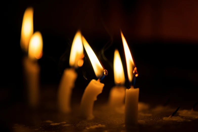 a row of candles in a dark room