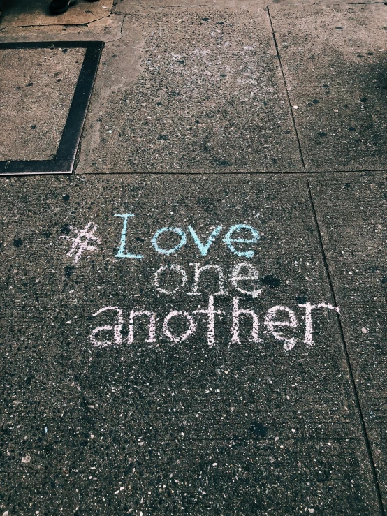 a love on the sidewalk has chalk writing on it