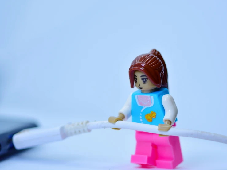 a lego toy holding a toothbrush with the toothpaste removed