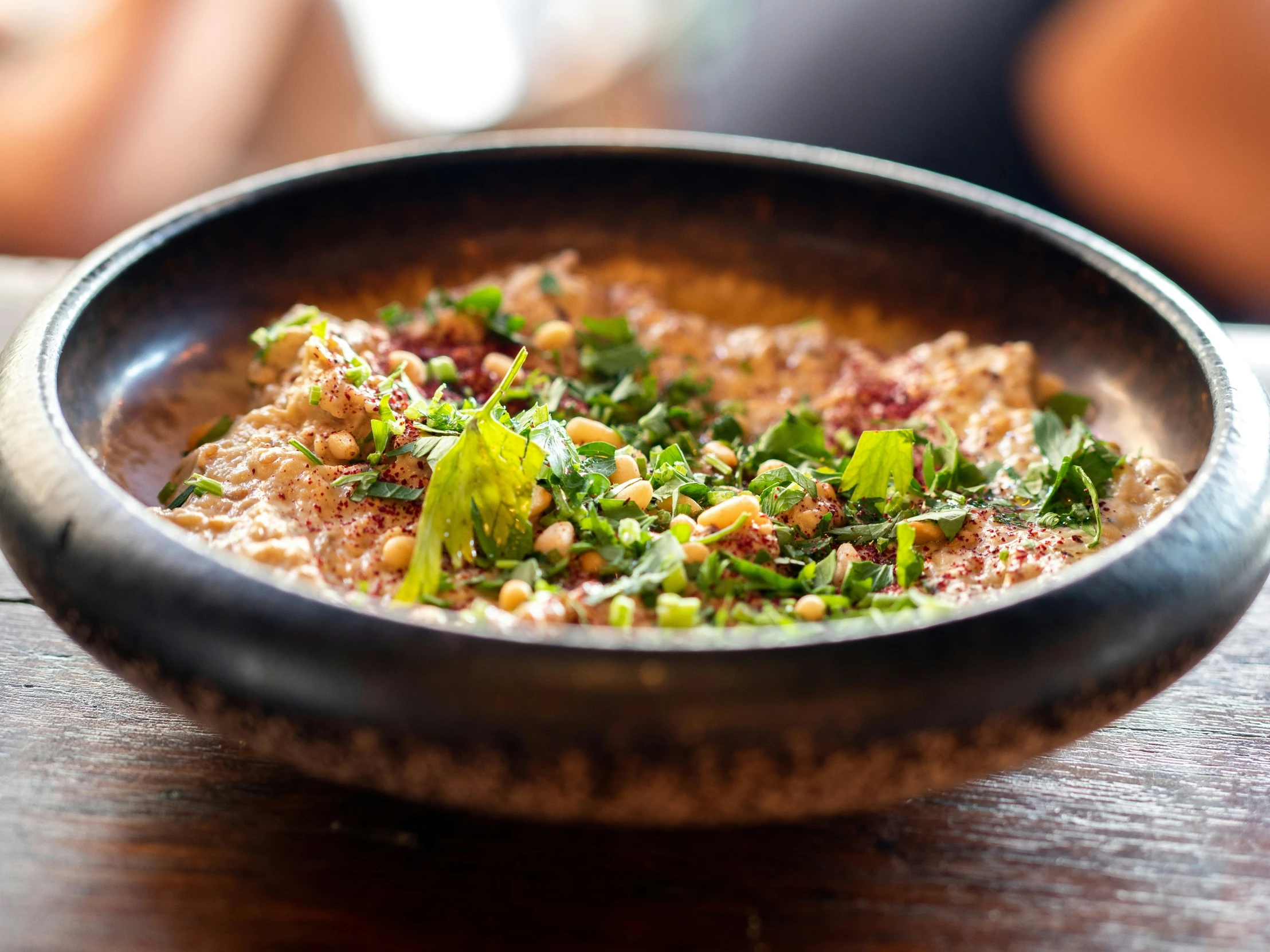 the food is inside of a wooden bowl