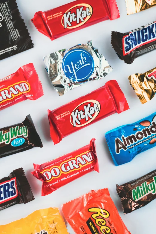 a group of assorted candies are arranged on a white surface