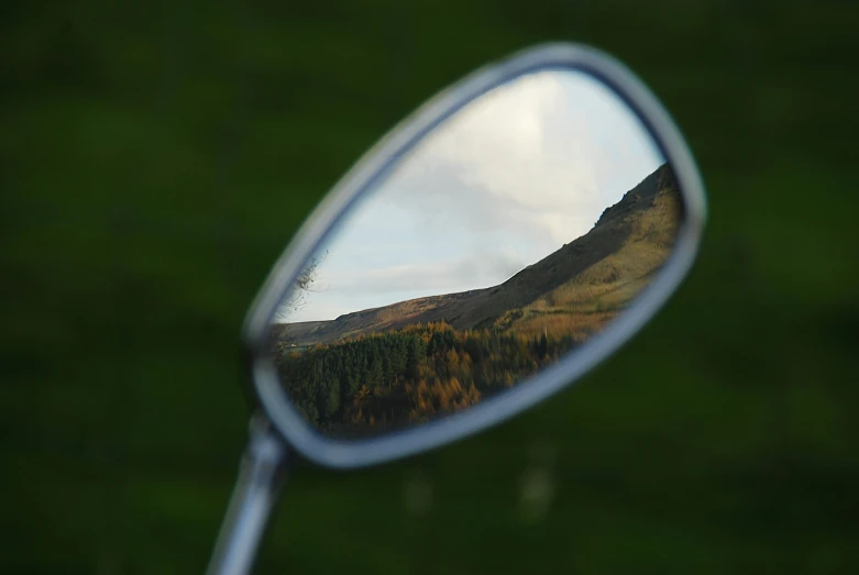 a mirror reflects mountains on the outside