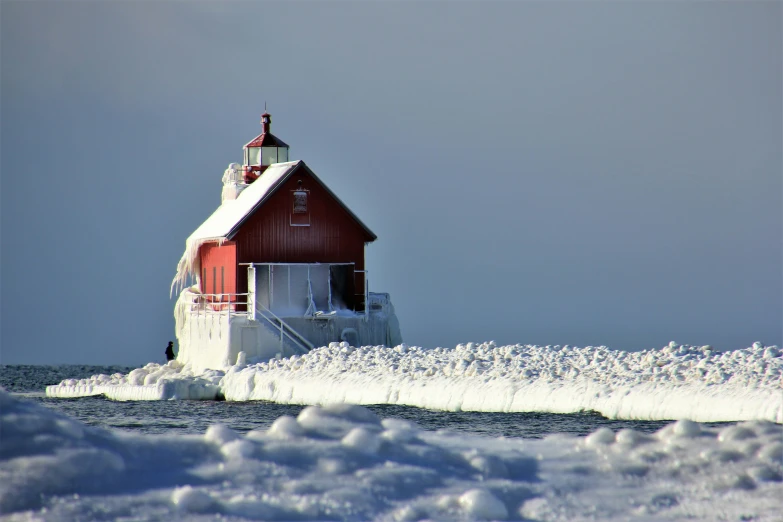 a red house with snow and ice around it