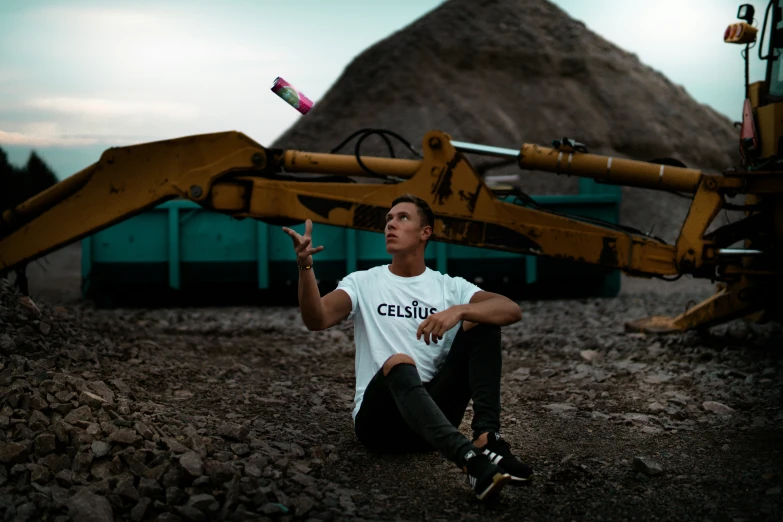 a man is sitting next to a tractor