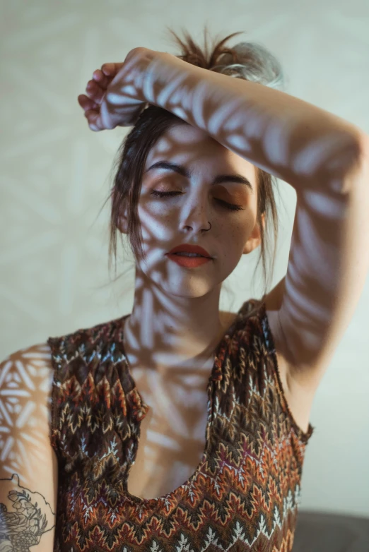 a woman holding her head with her hands while posing