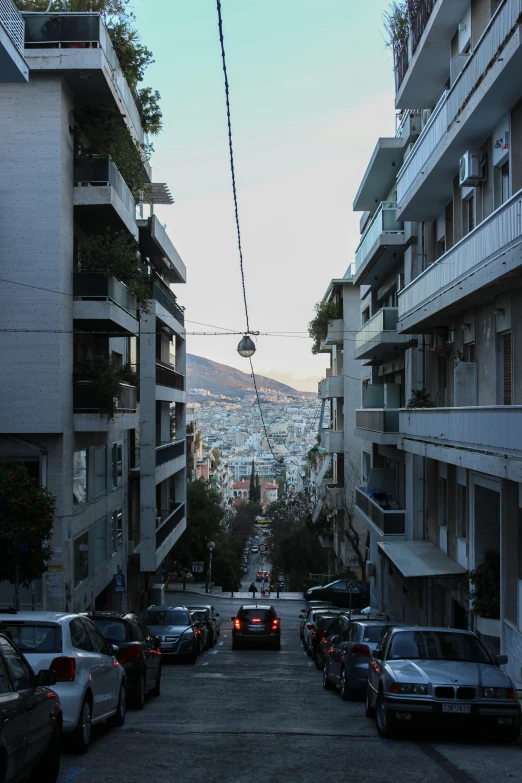 there is a street with parked cars in it