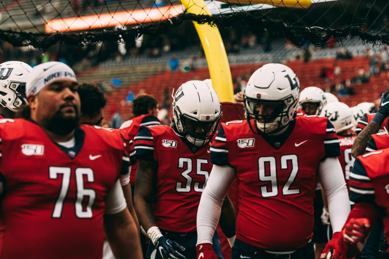 a football team in uniforms walking out onto the field