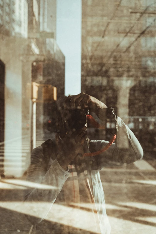 a woman is holding her hat out on a street