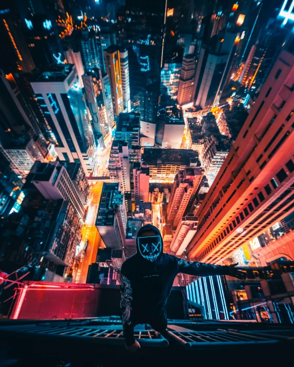 man wearing a full protective mask looks down at the city in the night