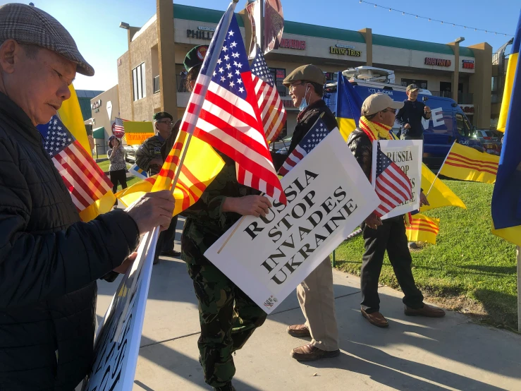 the men are holding flags and holding signs