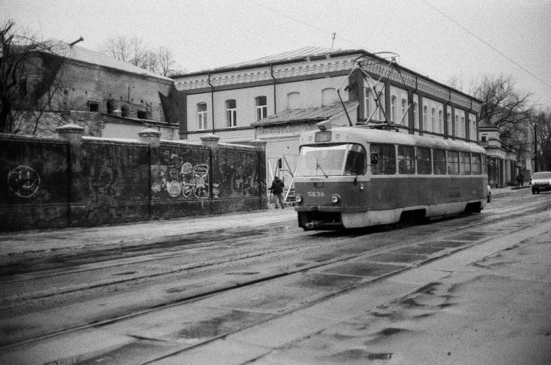 a black and white po of a streetcar passing through an old town