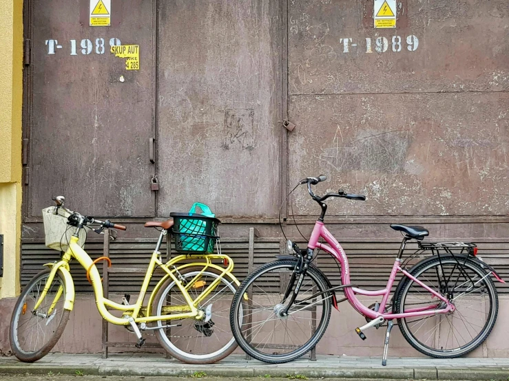 the bikes are parked on the side of the building