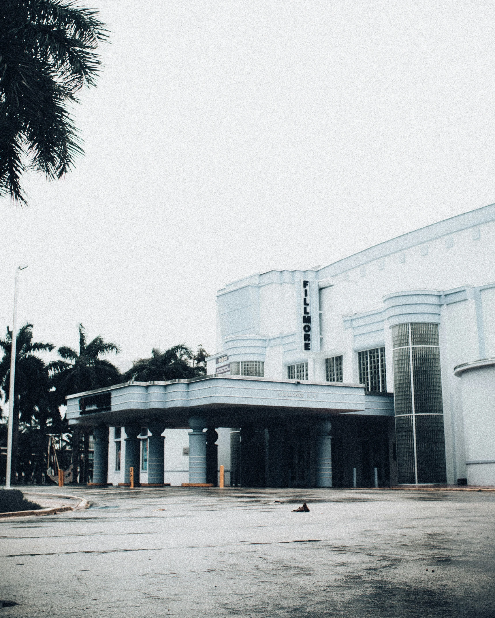 a building and some trees and cars in front