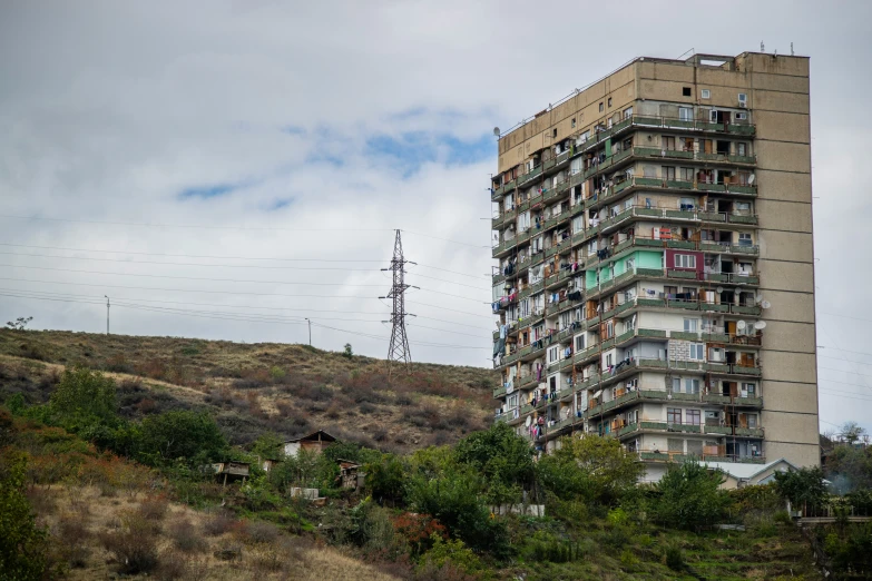 two tall buildings stand on a hilly hill