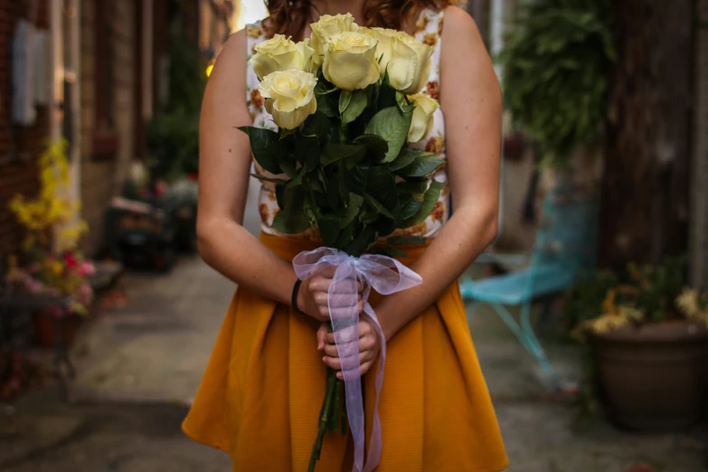 a young woman holding a bouquet of flowers