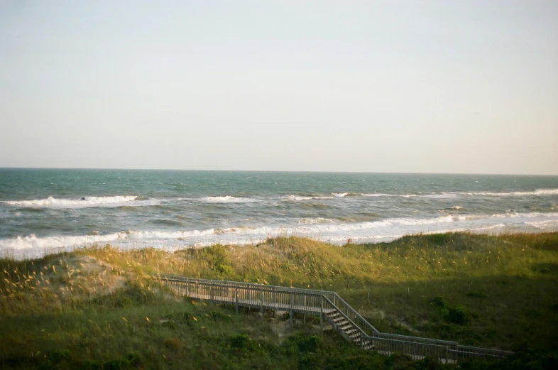 the stairs lead down into the ocean from a beach