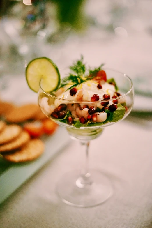 a small goblet filled with food next to ers and bread