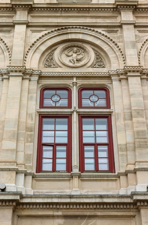 a large building with red windows and brown columns