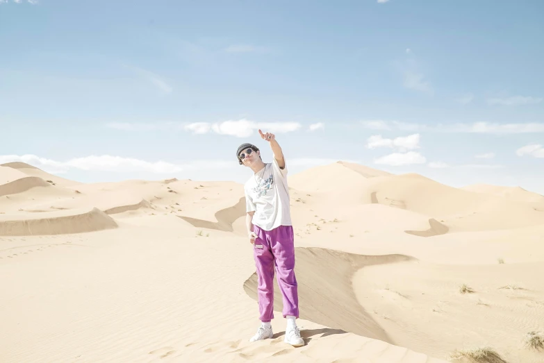 a person standing on top of a sandy beach