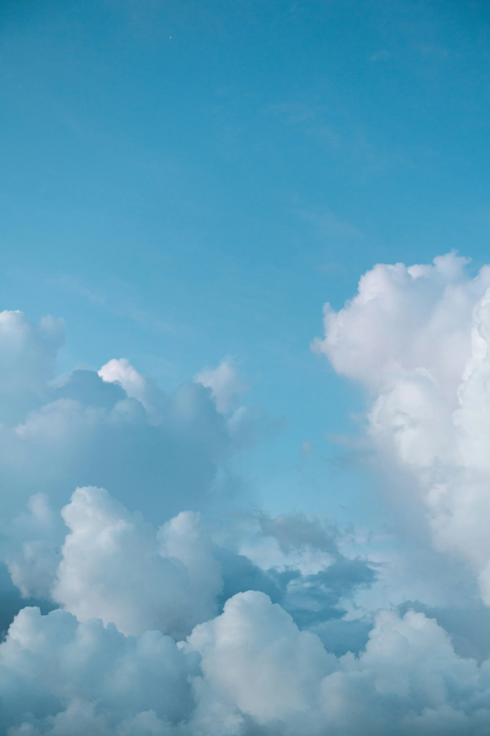 an airplane is flying in the blue sky