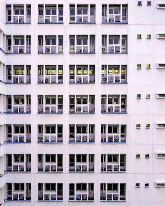 multiple windows and balconies on a large, white building