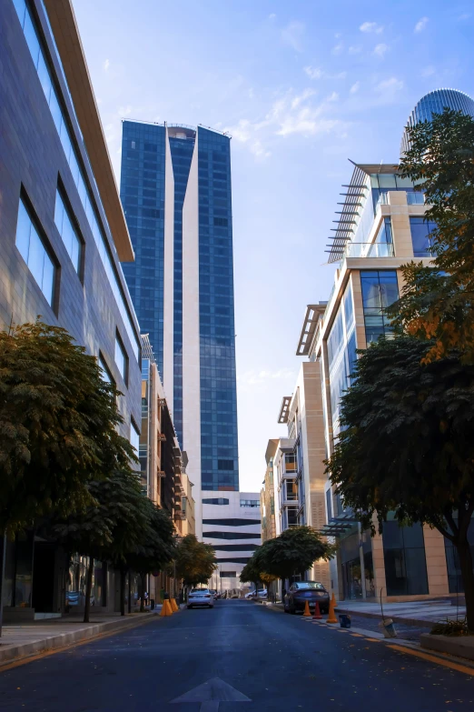 an empty street that has skyscrs in the background