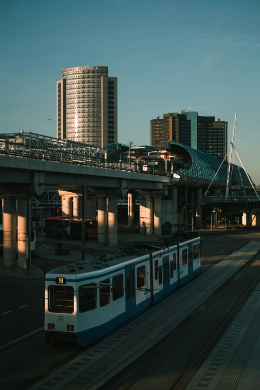 a white train travels along an elevated station