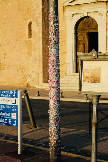 the pole is in front of the building and has a lot of confetti on it