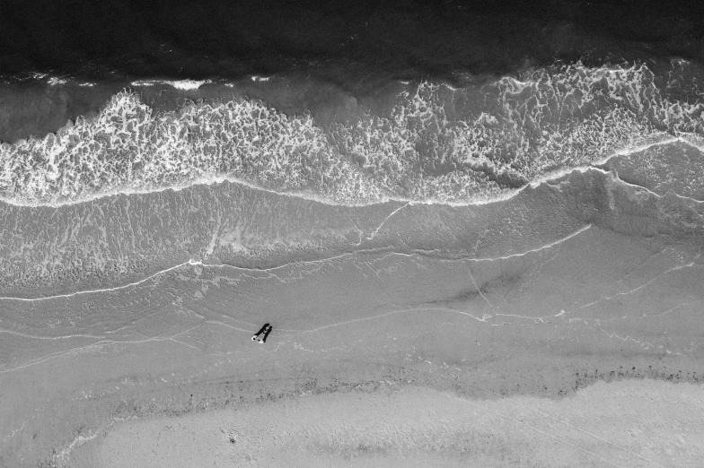 a lone person walking down the beach at night